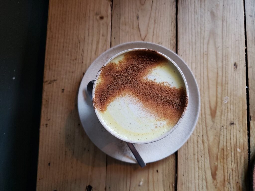Turmeric latte with foam art in turmeric latte vs golden milk comparison